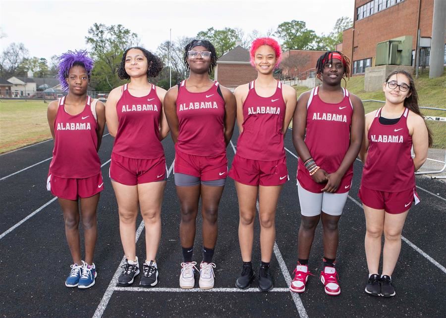 The ASD girls' track & field team poses for its team photo on the track at Kiwanis Field